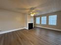 Bright living room featuring hardwood floors, a fireplace with white mantel, and plenty of natural light at 5488 Wexford Pass, Atlanta, GA 30349