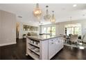 Spacious kitchen with a large center island, wood floors, and an adjacent dining area at 2446 Naples St, Hoschton, GA 30548