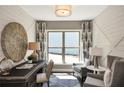 Home office featuring a dark desk, two chairs, modern decor, and a large window at 2446 Naples St, Hoschton, GA 30548