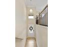 Bright foyer featuring hardwood floors, high ceilings, and decorative chandelier at 5047 Chesterfield Ln, Dunwoody, GA 30338