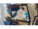Aerial view of a home with a backyard featuring a sparkling swimming pool and patio area at 5160 Meridian Pass, Cumming, GA 30028
