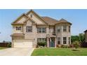 Charming two-story home featuring a brick facade and well-maintained landscaping at 5160 Meridian Pass, Cumming, GA 30028