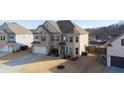 Charming home showcasing a brick and siding façade, a neatly kept lawn, and an attached two-car garage with a driveway at 5160 Meridian Pass, Cumming, GA 30028
