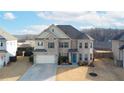 Beautiful home featuring a combination of brick and siding, a well-maintained lawn, and a convenient two-car garage at 5160 Meridian Pass, Cumming, GA 30028