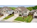 Beautiful two-story home with manicured lawn and attached two-car garage at 5160 Meridian Pass, Cumming, GA 30028
