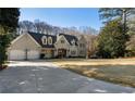 Charming two-story home with a well-maintained lawn, long driveway, and attached two car garage at 3258 Teton Se Dr, Atlanta, GA 30339