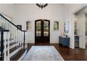 Grand foyer with a staircase, chandelier, dark wood flooring, and a decorative rug at 3258 Teton Se Dr, Atlanta, GA 30339