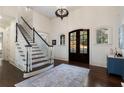 Elegant foyer featuring hardwood floors, staircase, chandelier, and decorative rug at 3258 Teton Se Dr, Atlanta, GA 30339