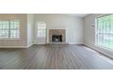 Inviting living room with hardwood floors, a brick fireplace and large windows for natural light at 5500 Marbut Forest Way, Lithonia, GA 30058