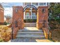 Charming brick entrance featuring a stylish archway and well-maintained landscaping at 677 Brennan Dr, Decatur, GA 30033