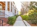 Exterior view showing a row of beautiful brick townhomes with manicured landscaping at 677 Brennan Dr, Decatur, GA 30033