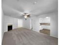 Open-concept living room with a fireplace and view into the white kitchen at 1090 Ohara Dr, Jonesboro, GA 30236