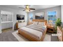 Stylishly staged main bedroom with large windows, ensuite bathroom, and modern decor at 1090 Ohara Dr, Jonesboro, GA 30236