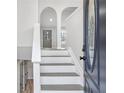 Bright foyer featuring staircase, neutral walls, and a decorative front door, creating a welcoming entrance at 161 Kingswood Dr, Ellenwood, GA 30294