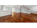Open-concept living space with hardwood floors and neutral gray walls at 3744 Misty Wood Nw Dr, Marietta, GA 30064
