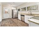 Well-lit kitchen featuring stainless steel appliances, granite countertops, and wood-look floors at 1145 Canal St, Decatur, GA 30032