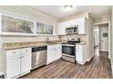 Updated kitchen with stainless steel appliances, granite counters, and white cabinetry at 1145 Canal St, Decatur, GA 30032