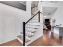 Elegant staircase in a bright foyer with hardwood floors, white walls, and decorative accents at 2383 Colonial Ne Dr, Brookhaven, GA 30319