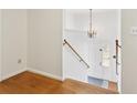 Bright foyer with hardwood floors, chandelier, and a wooden handrail showcases the home's entryway at 1426 Diamond Head Dr, Decatur, GA 30033