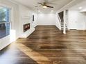 Spacious living room featuring gleaming hardwood floors, a fireplace, and ample natural light at 1444 Twin Branches Se Cir, Marietta, GA 30067