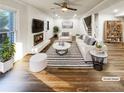 Bright living room with hardwood floors, fireplace, and stylish decor; staged for appeal at 1444 Twin Branches Se Cir, Marietta, GA 30067