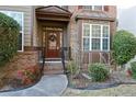 Charming front door entrance with brick accents and a welcoming wreath at 460 Chandler Bluff Ct, Grayson, GA 30017