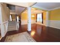 Spacious living room featuring hardwood floors, columns, and ample natural light at 460 Chandler Bluff Ct, Grayson, GA 30017