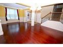 Bright and spacious living room featuring hardwood floors, large windows, and a staircase at 460 Chandler Bluff Ct, Grayson, GA 30017