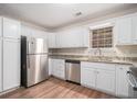 Bright kitchen with stainless steel appliances, white cabinets, and granite countertops, perfect for cooking at 100 Hunters Keep Trce, Covington, GA 30014