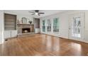 Spacious living room featuring hardwood floors, fireplace, and large windows at 3084 Brookshire Way Way, Duluth, GA 30096