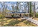 Charming single-story home with a covered carport and a well-maintained front yard at 3651 Tulip Dr, Decatur, GA 30032