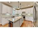 Spacious kitchen with white cabinets, stainless steel appliances, and granite countertops at 370 Laurel Oak Dr, Suwanee, GA 30024