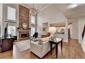 Bright living room features a stone fireplace, high ceilings, and hardwood floors at 370 Laurel Oak Dr, Suwanee, GA 30024