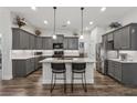 Modern kitchen featuring gray cabinets, granite countertops, stainless steel appliances, and a center island at 48 Lantern Trce, Hiram, GA 30141