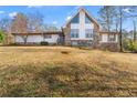 Exterior view of a home featuring stone and siding with a large front yard at 3222 Bay View Dr, Jonesboro, GA 30236