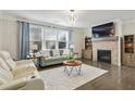 Comfortable living room with fireplace, TV, and ample seating at 167 Marlow Dr, Woodstock, GA 30188