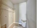 Well-lit laundry room with ample storage shelves and space for laundry basket and a white shag rug at 1988 Boulderview Se Dr, Atlanta, GA 30316