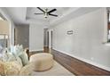 Bright living room features hardwood floors, tray ceiling, neutral paint, and access to multiple rooms at 1988 Boulderview Se Dr, Atlanta, GA 30316