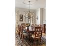 Cozy dining room with decorative chandelier, seating for eight, and hardwood floors at 2146 Wolbert Trl, Marietta, GA 30062