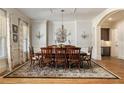 Formal dining room with large windows, elegant chandelier, and seating for eight at 2146 Wolbert Trl, Marietta, GA 30062