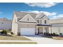 Charming two-story home with a well-maintained lawn and an attached two-car garage at 7783 Hansel Ln, Lithonia, GA 30058