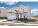 Charming two-story home with a well-maintained lawn and an attached two-car garage at 7783 Hansel Ln, Lithonia, GA 30058