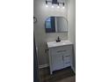 Modern bathroom features a white vanity with drawers, a black faucet, and stylish mirror at 3201 Fairington Dr, Lithonia, GA 30038