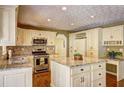 Well-appointed kitchen featuring granite countertops, stainless steel appliances, and custom cabinetry at 596 Whitby Dr, Douglasville, GA 30134