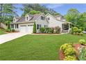 Stylish home featuring an attached garage and beautifully landscaped front yard at 1870 Shoreline Trce, Grayson, GA 30017
