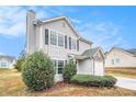 Attractive gray home with black shutters and a stone-accented attached garage at 4872 Antelope Cv, Atlanta, GA 30349