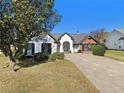 Beautiful single-story home featuring a well-manicured lawn and inviting curb appeal at 690 Avalon Forest Dr, Lawrenceville, GA 30044