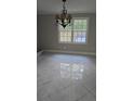 Dining room featuring tile floors, a window, and a chandelier at 1947 Kensington High Sw St, Lilburn, GA 30047