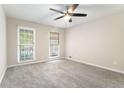 Cozy bedroom with two windows, and neutral gray carpet at 372 Rustic Ridge Cir, Lawrenceville, GA 30043