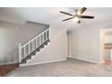 Bright living room with a staircase and a ceiling fan, creating a welcoming space at 372 Rustic Ridge Cir, Lawrenceville, GA 30043